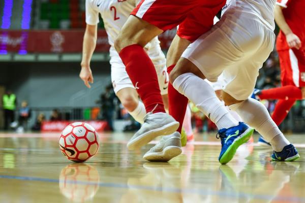 Futsal players compete for the ball