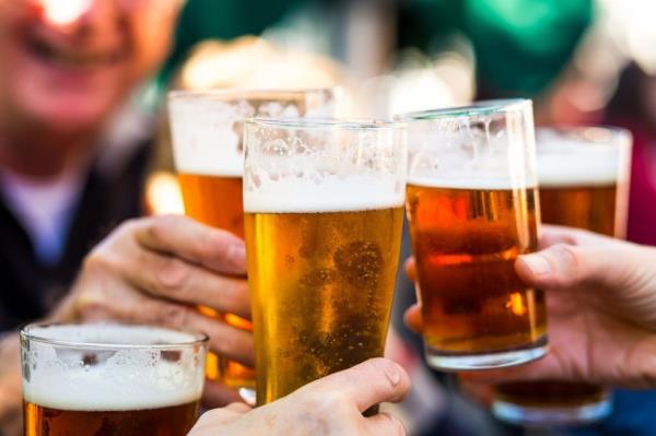 People cheers their glasses of beer (pints of beer) together in a gesture of celebration