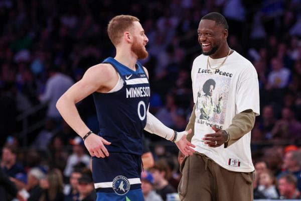 Donte DiVincenzo and Julius Randle in basketball uniforms celebrating during a preseason NBA game between Minnesota Timberwolves and New York Knicks on Oct. 13, 2024.