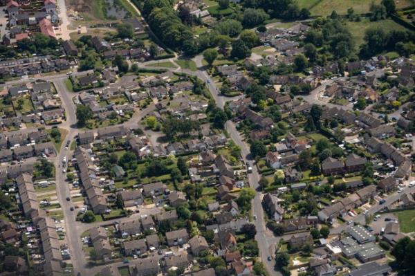 Aerial view flying over rows of townhouses, outside London in town of Slough UK