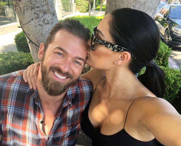 Artem Chigvintsev and Nikki Bella pose togehter in 2019.
