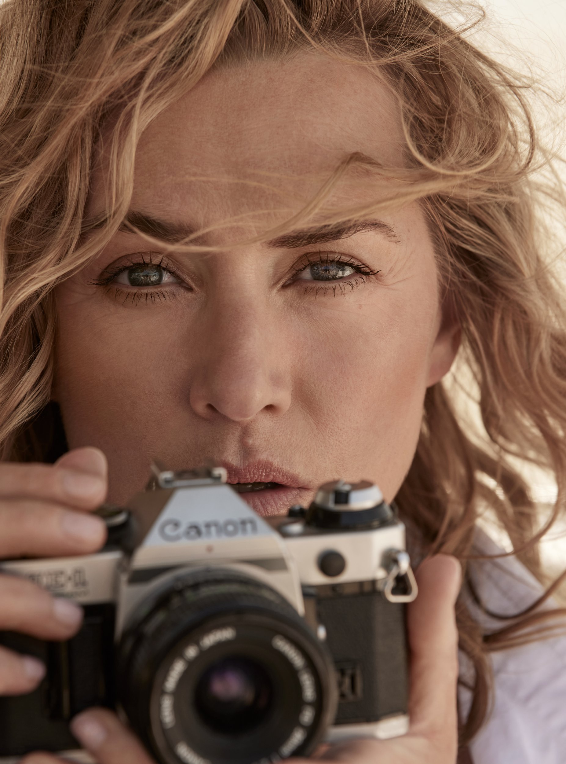 Close up of Kate Winslet holding up a camera