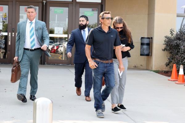 Bergman leaving court with her father.