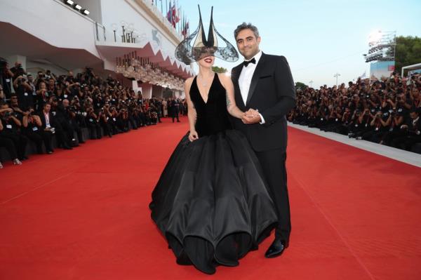 Lady Gaga comforted her fiancé Michael Polansky as the pair walked the red carpet together at the Venice International Film Festival.