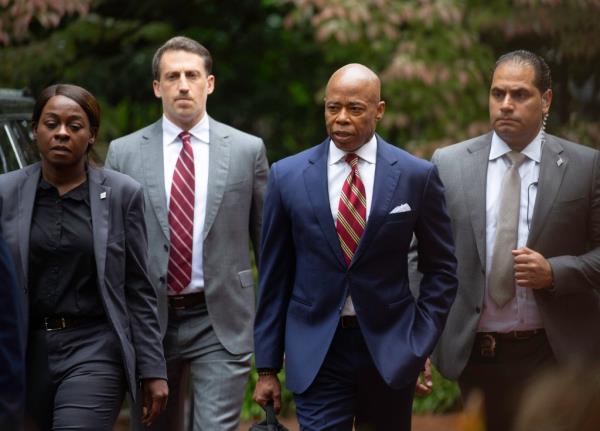 Attorney for NYC Mayor Eric Adams, Alex Spiro (tall, greay suit with red and white striped tie), asserts his client's innocence to the media on the driveway of Gracie Mansion in Manhattan, NY on September 26, 2024, following the FBI's indictment of Adams on Septemebr 25, 2024.
