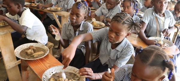 Students eat lunch at their school in Belle onde village, in central Haiti, in April 2024.