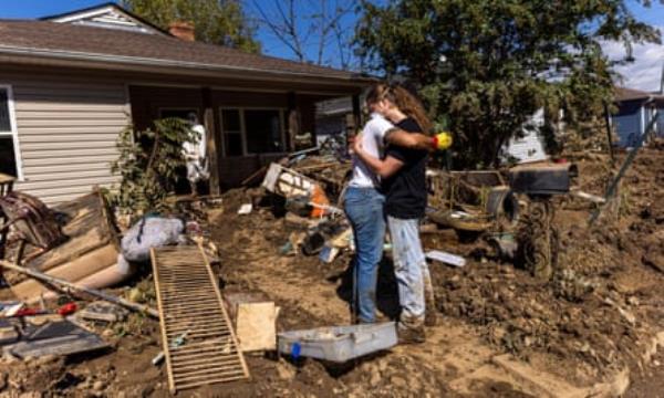 Aftermath of Hurricane Helene in North CarolinaPeople react, as volunteers help to clean their home covered in mud