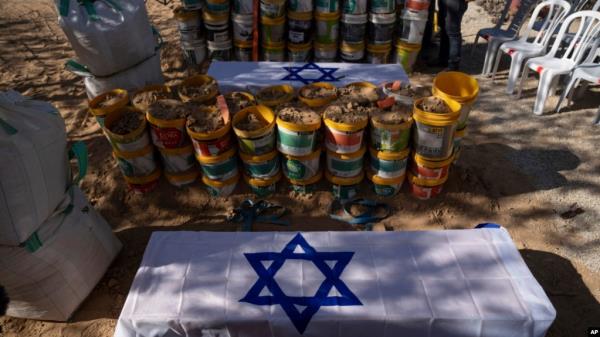 The coffins of Roee Munder who was killed on Oct. 7, 2023, and is being reburied, and his father, Avraham Munder, who was killed in Hamas captivity and recovered by the Israeli military in Gaza, lie together at the Kibbutz Nir Oz, Israel, Aug. 21, 2024. 