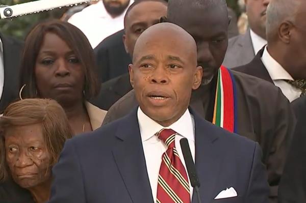 Mayor Adams speaks in front of Gracie Mansion alongside supporters. 