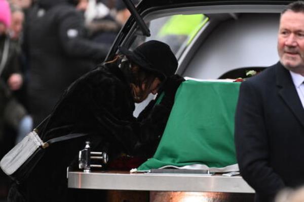 Victoria Mary Clarke pauses by the coffin of her husband Shane MacGowan. Picture: Larry Cummins Victoria Mary Clarke pauses by the coffin of her husband Shane MacGowan. Picture: Larry Cummins