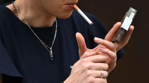 Getty Images A woman is seen smoking a cigarette in central London.