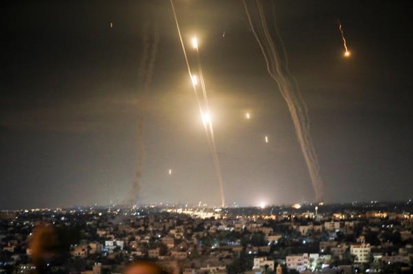 Explosions as a result of Israeli aircraft bombing resistance positions in Gaza City and the resistance launching missiles towards Israel at the same time