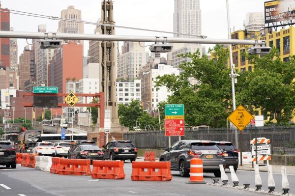 A general view of a congestion pricing toll gantry with the Empire State Building behind it as seen on W40th Street in New York, NY on June 5, 2024.