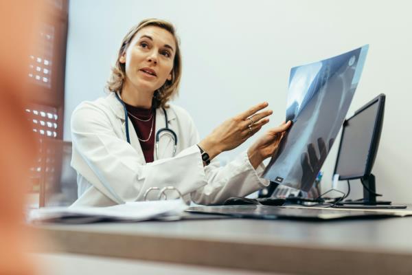 A doctor showing an x-ray.