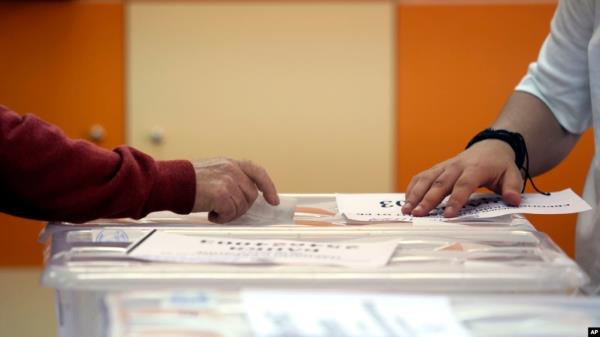 FILE - An early voter casts his vote in the polling station on the outskirts of Sofia, Bulgaria, June 9, 2024.