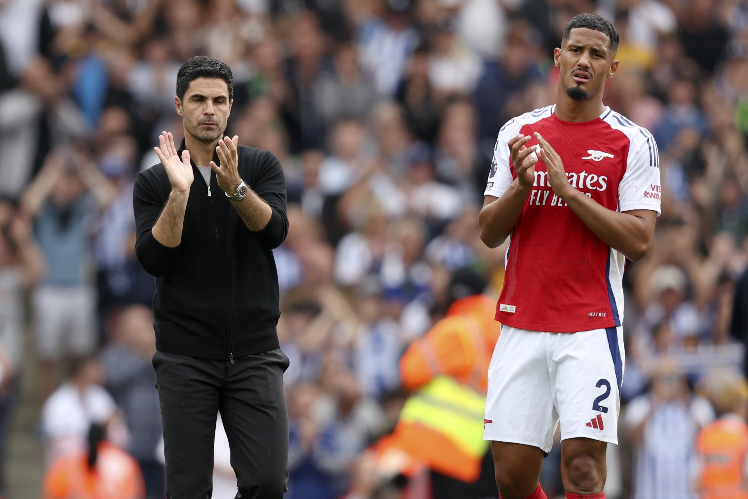 Mikel Arteta, Manager of Arsenal and William Saliba of Arsenal applauds the fans after the Premier League match between Arsenal FC and Brighton & Hove Albion FC at Emirates Stadium on August 31, 2024 in London, England