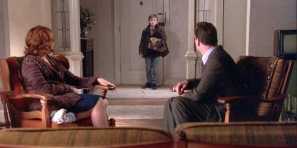 Malcolm sits across from Lynn as Cole comes home in The Sixth Sense