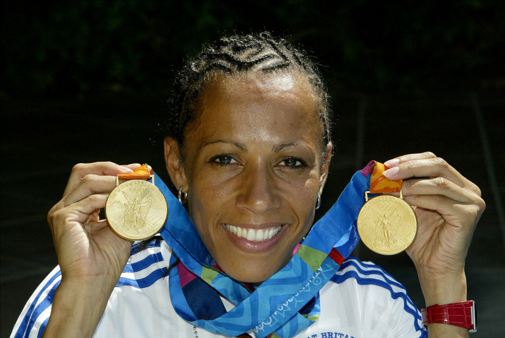 Kelly Holmes of Great Britain celebrates With Gold Medals after the Olympic Games in Athens, 2004