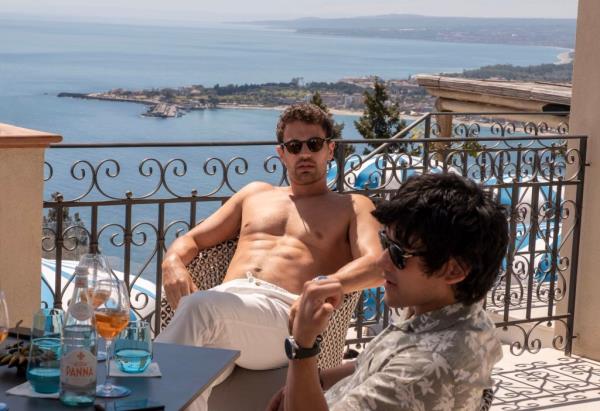 Theo James in White Lotus reclining, shirtless.