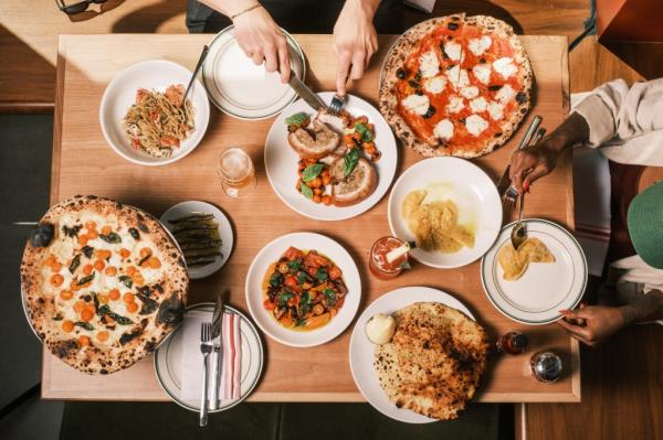 Roberta's Bushwick pizzeria serving margherita pizza, corn mezzaluna pasta, and a $31 poori at their new location in Penn Plaza, midtown Manhattan.