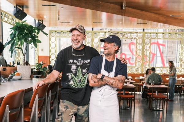 Brandon Hoy and Carlo Mirarchi standing in the dining room of Roberta's in Manhattan