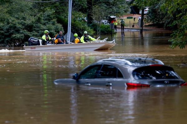 Members of the Atlanta Fire Rescue
Department's Swift Water Rescue Team bring Darryl Hall (C) to dry land after his Buckhead neighborhood home was swamped by the flood waters of Peachtree Creek in the aftermath of Tropical Storm Helene in Atlanta, Georgia, USA, 27 September 2024.