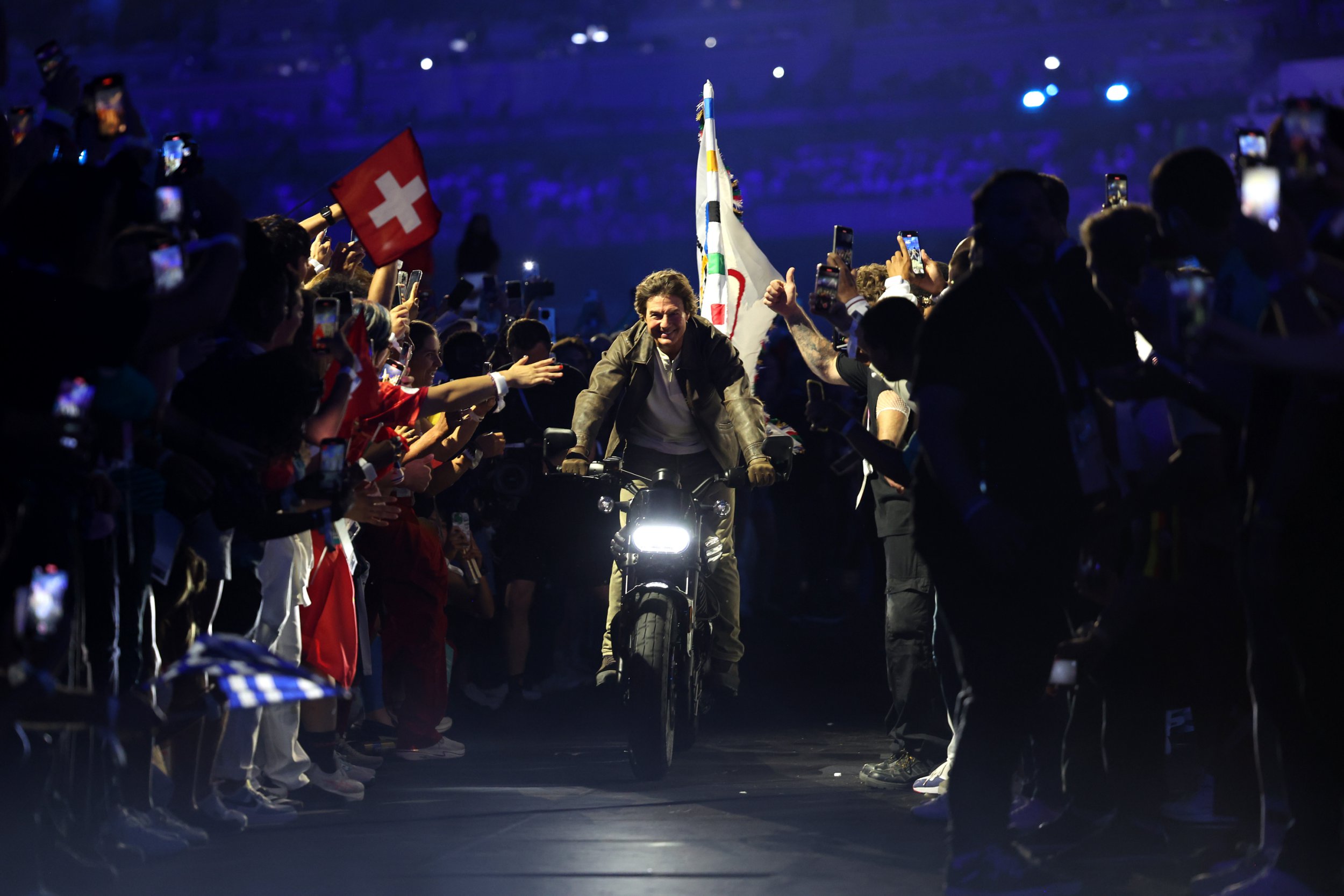Tom Cruise on a motorbike in State de France during the 2024 Summer Olympics closing ceremony.