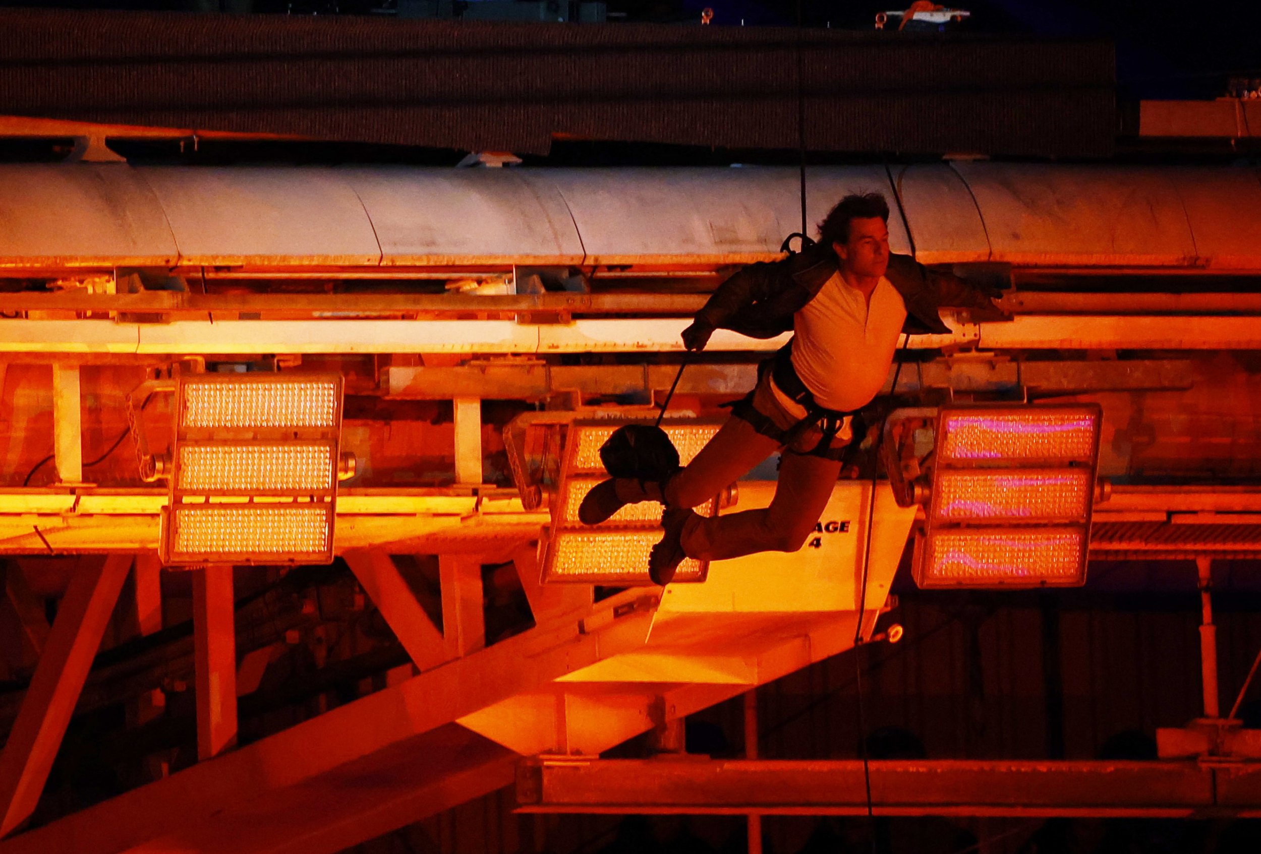 Tom Cruise is lowered on the State de France during the 2024 Summer Olympics closing ceremony.
