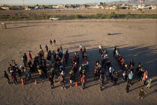 U.S. Customs and Border Protection officers prepare to transport migrants who crossed the U.S.-Mexico border at the Rio Grande river from Ciudad Juárez, Mexico to a vehicle for transportation to a facility for processing on Thursday, October 3, 2023 in El Paso, Texas. (NYPJ for New York Post)