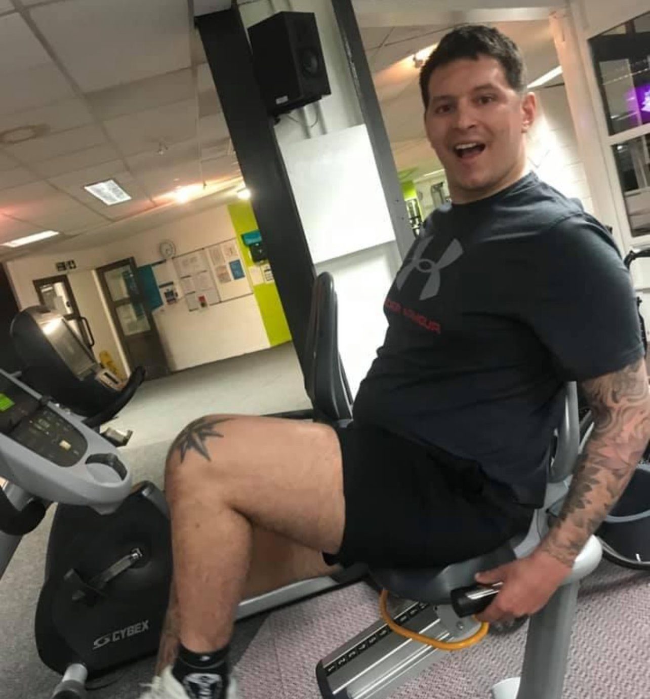 Marlon sitting on gym equipment smiling