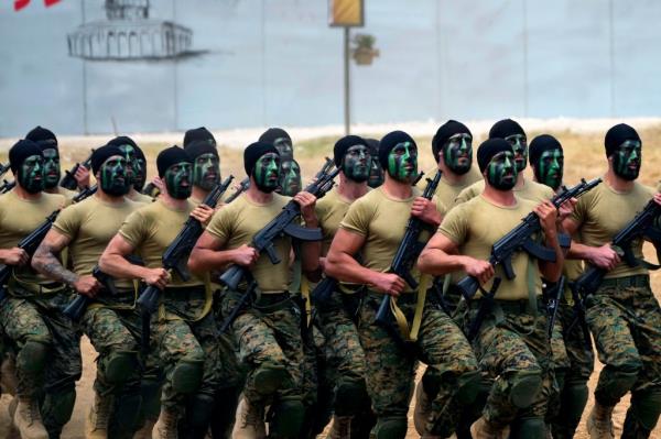 Fighters from the Lebanese militant group Hezbollah carry out a training exercise in Aaramta village in the Jezzine District, southern Lebanon, Sunday, May 21, 2023.