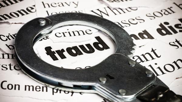 Handcuffs encircling 'fraud'