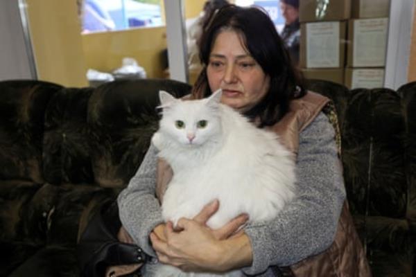 Kupiansk resident holding her white cat 
