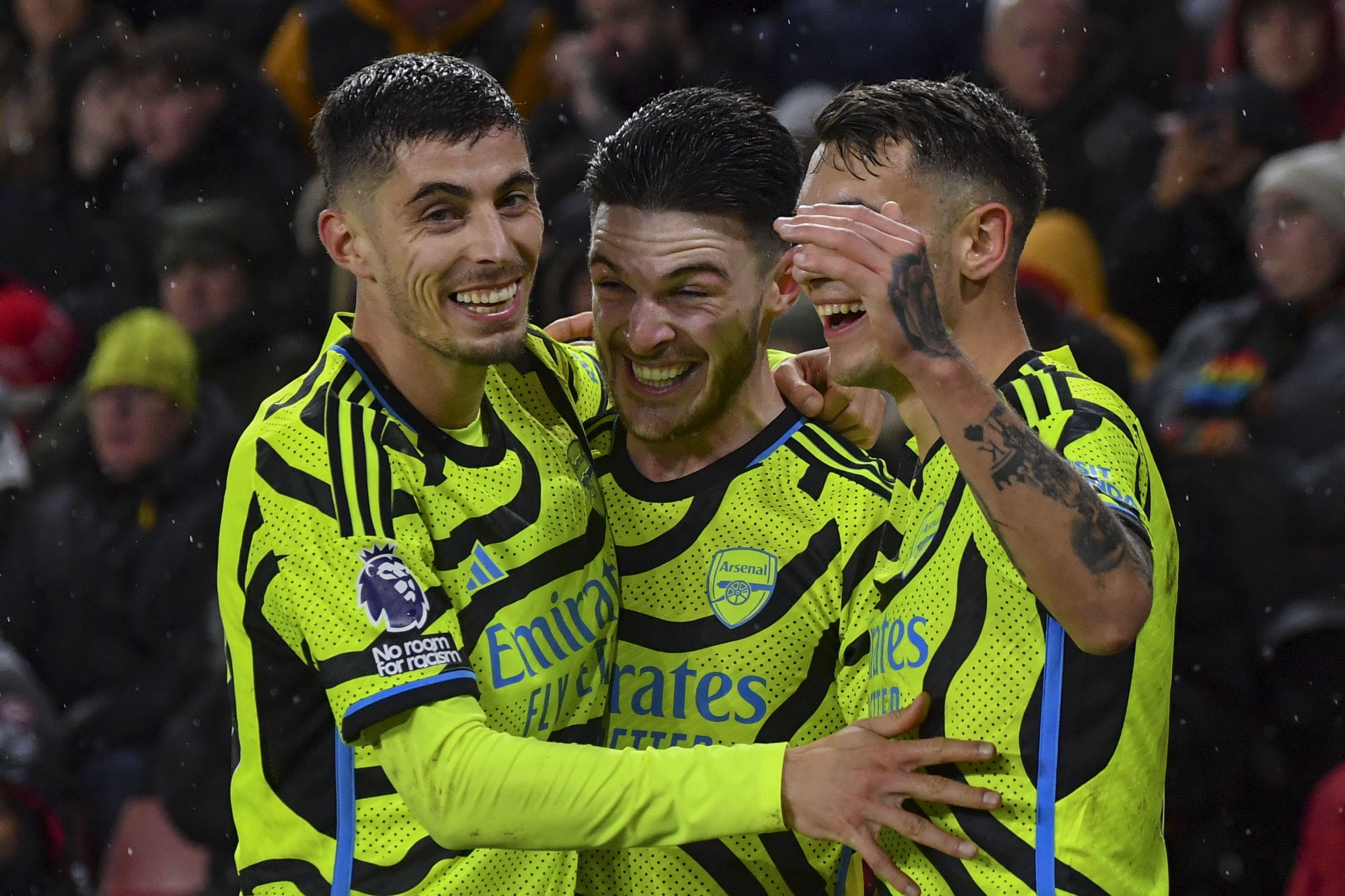 Arsenal's Declan Rice, center, celebrates with teammates after scoring his side's fifth goal during the English Premier League soccer match between Sheffield United and Arsenal at the Bramall Lane