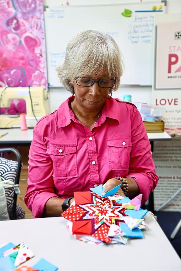 Sam making art with multi-coloured cloths.