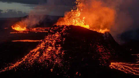 Getty Images Lava spews from multiple craters of the Sundhnúkur volcano on June 3, 2024 on the Reykjanes peninsula near Grindavik, Iceland. 