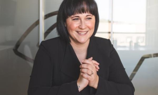 Woman in black clasping hands