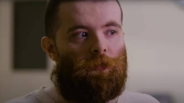 Nicholas Godejohn looks left