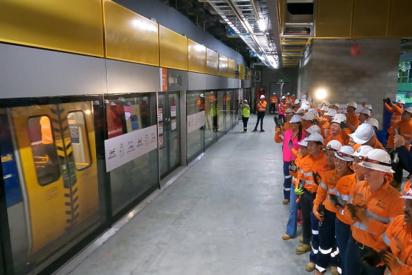 Workers at Roma Street welcome the first train through Brisbane’s Cross River Rail twin tunnel underground system.