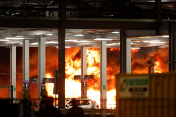 Flames are seen as emergency services respond to a fire in Terminal Car Park 2 at London Luton airport in Luton, Britain, October 10, 2023