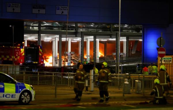 Flames are seen as emergency services respond to a fire in Terminal Car Park 2 at London Luton airport in Luton, Britain, October 10, 2023.