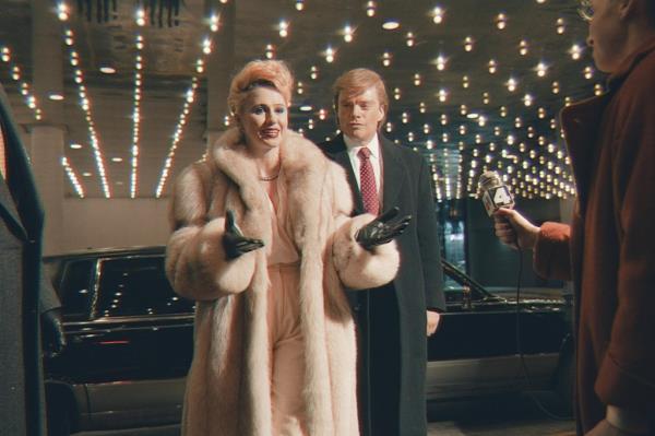 Maria Bakalova and Sebastian Stan as Ivana and Donald Trump smiling