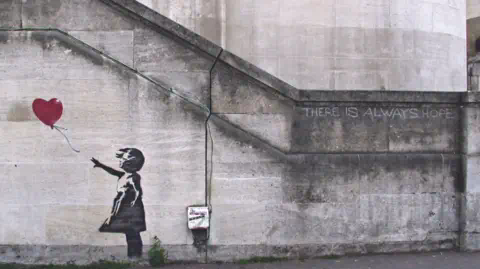 Banksy Mural of Girl with Balloon stencil on wall