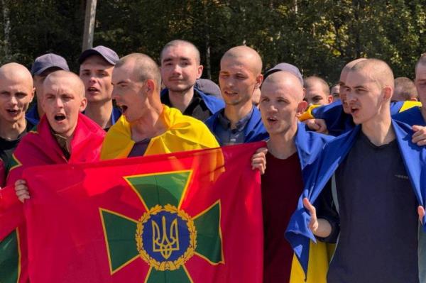 Ukrainian prisoners of war (POWs) react after a swap, amid Russia's attack on Ukraine, at an unknown location in Ukraine, in this handout picture