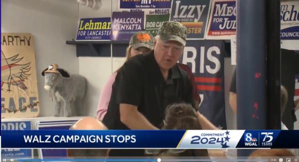 Tim Walz, clad in a black shirt, during his visit to Lancaster, Pa., receiving mixed reactions from voters.
