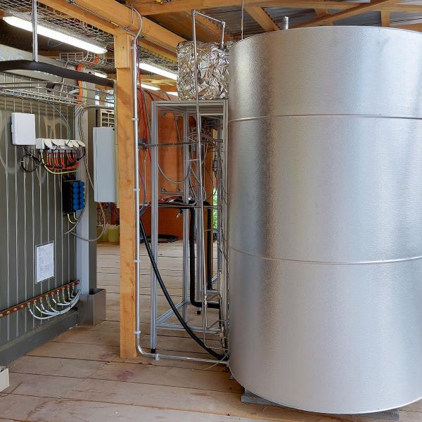 Stainless steel boiler in a shed.