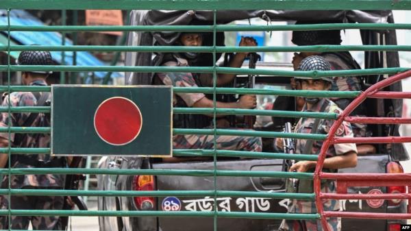 Bangladeshi border guard personnel stand guard at the India-Bangladesh border of Petrapole, about 100 kilometers (62 miles) northeast of Kolkata, on Aug. 6, 2024.