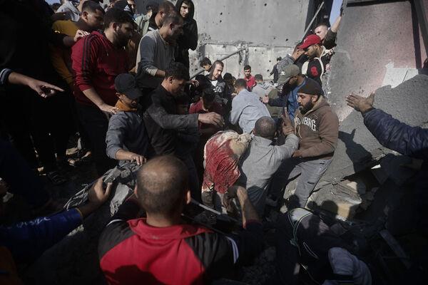 Palestinians evacuate survivors of the Israeli bombing In Khan Younis refugee camp in Gaza Strip on Friday. Picture: AP Photo/Mohammed Dahman Palestinians evacuate survivors of the Israeli bombing In Khan Younis refugee camp in Gaza Strip on Friday. Picture: AP Photo/Mohammed Dahman