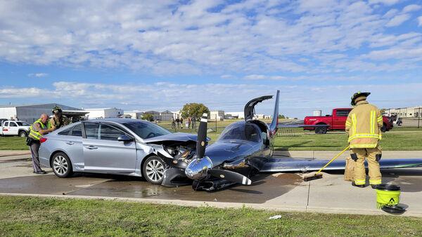 Small plane crashes into car after overshooting runway during emergency landing