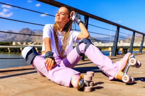 young woman roller skating outside